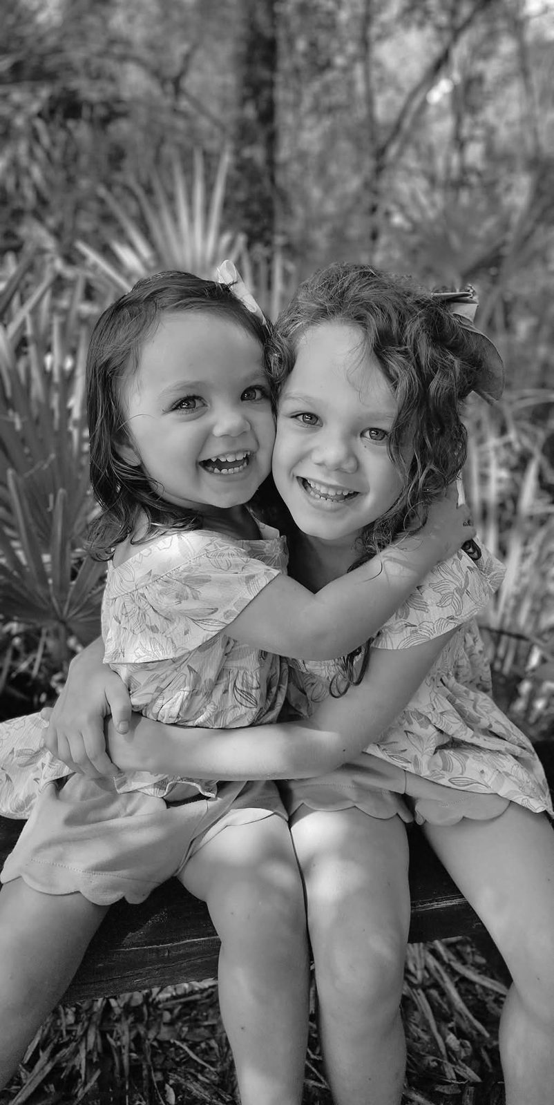 Sisters hugging, black and white