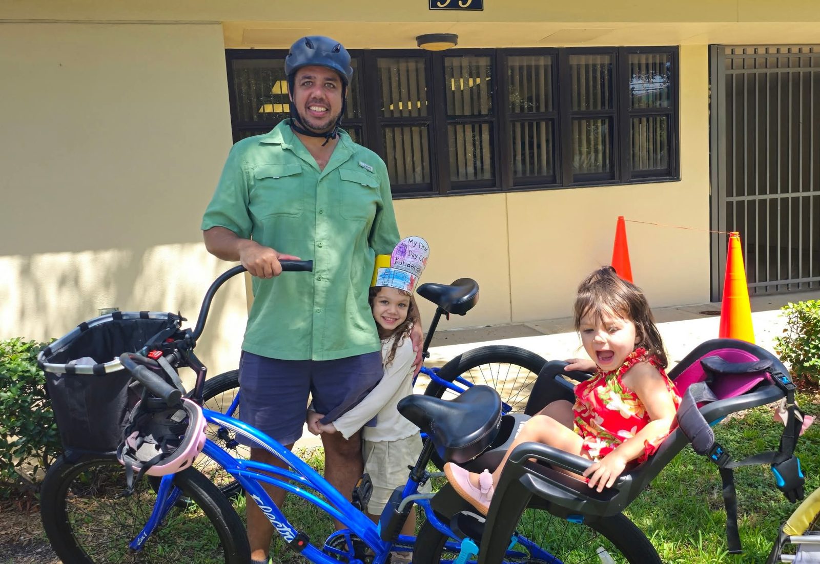 Dad and daughters with the family bike